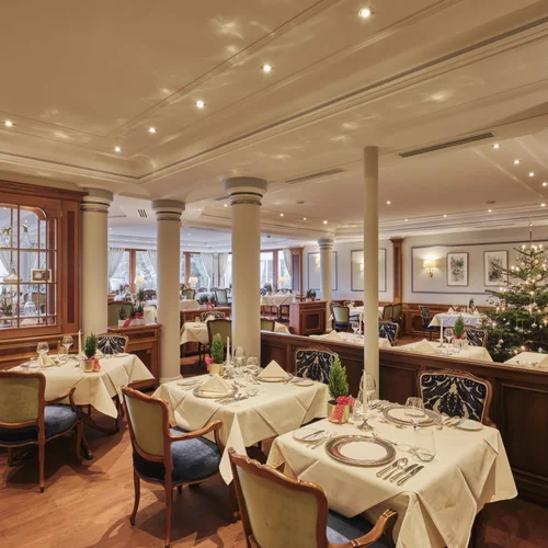 Restaurant dining room with set tables and a decorated Christmas tree