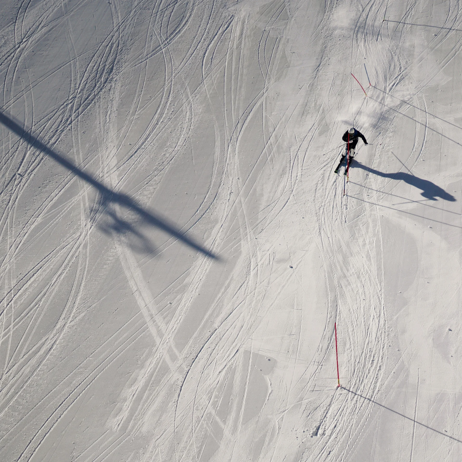 Person beim Skifahren auf verschneiter Piste aus der Vogelperspektive